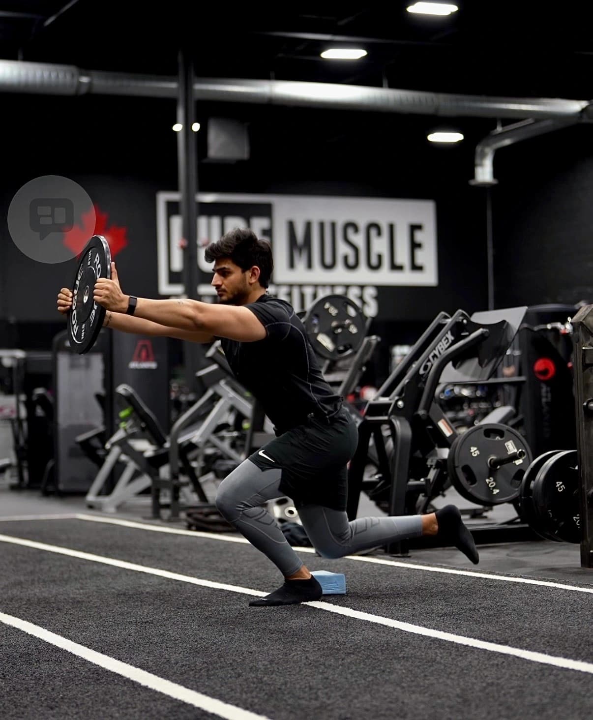 Coaching focus on movement quality — efficiency and control through the full range of motion. Athlete executing a barbell front-rack lunge with efficient mechanics and full range of motion