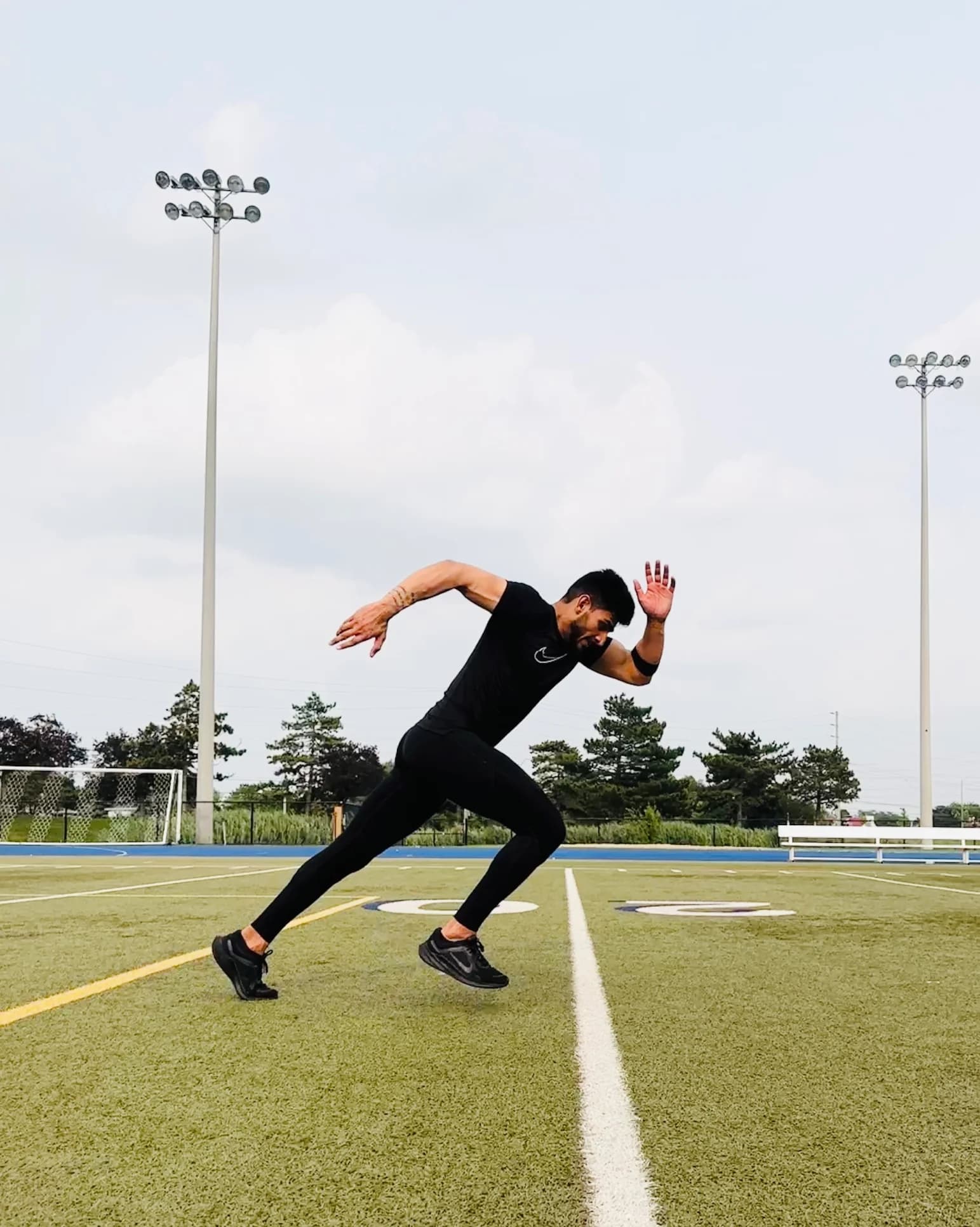 Coaching focus on positioning — body alignment and posture that protect the athlete and transfer to sport. Athlete in a deep lunge demonstrating precise body alignment and posture during strength training