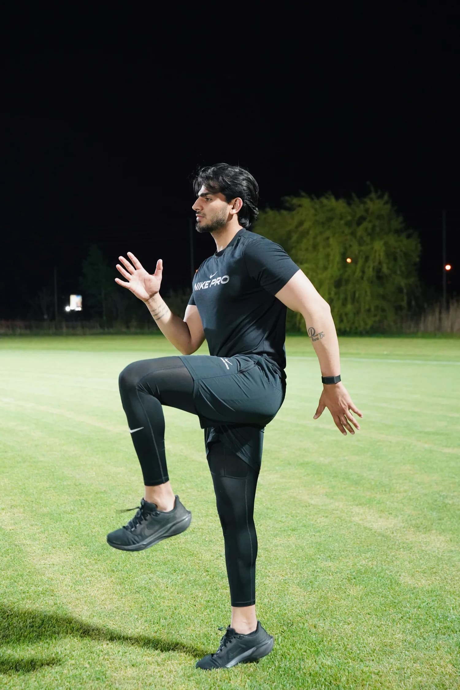 Coaching focus on rhythm — coordinated timing between limbs and segments during athletic movement. Athlete sprinting on a turf field showing coordinated timing between upper and lower body