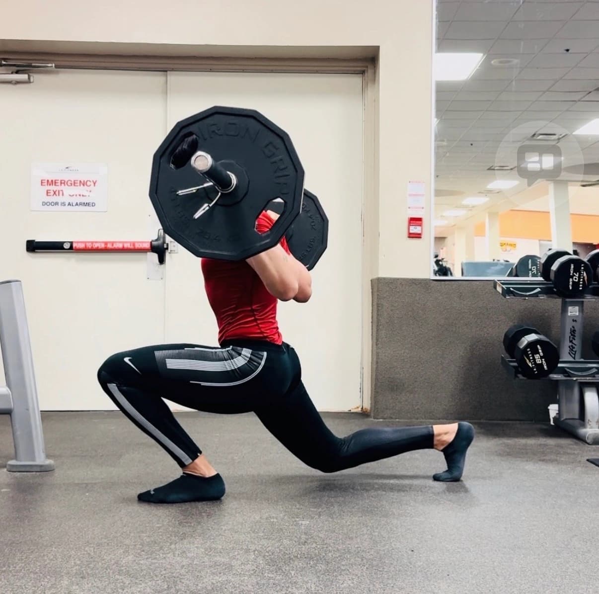 Coaching focus on tempo — controlled speed under load to build force production and durability. Athlete performing high knees drill with controlled tempo on a grass field at night
